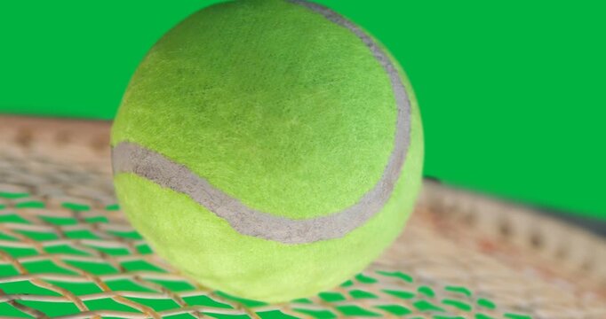 Close up of a tennis ball over a racket against copy space on transparent background
