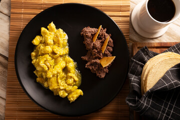Scrambled eggs in green sauce. A typical Mexican breakfast of scrambled eggs tossed in spicy green sauce, usually accompanied by beans and pot coffee.