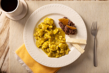Scrambled eggs in green sauce. A typical Mexican breakfast of scrambled eggs tossed in spicy green sauce, usually accompanied by beans and pot coffee.