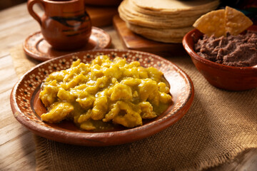 Scrambled eggs in green sauce. A typical Mexican breakfast of scrambled eggs tossed in spicy green sauce, usually accompanied by beans and pot coffee.