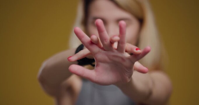 Young blonde woman stretching arms. indoor abstract close-up of hand