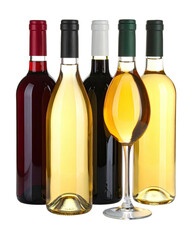 Wine bottles of different colors with a wine glass