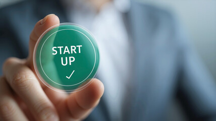 Businessman Touching Virtual Circular "START UP" Button with Correct Icon, Green Background,for Web Design and New Online Business Concept

