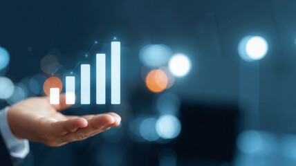 Businessman's Hand Holding a Blue Holographic Growth Bar Graph Icon, Symbolizing Stock Market and Financial Success, Against a Dark Office Background with Available Copy Space

