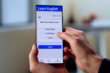 Senior Man Using Educational Smartphone App