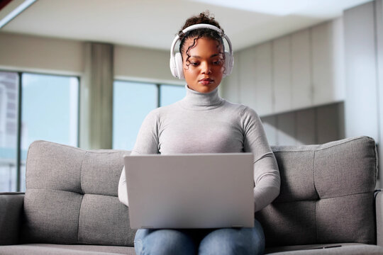African American Woman Holding Black Laptop