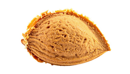 Close-up of a peach pit.  A single, light brownish-orange peach pit,  showing textured surface and slightly rough edges