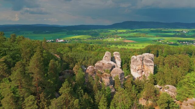 Aerial footage showcasing the sandstone rock formations of Hrub&aacute; Sk&aacute;la Rock City within the picturesque Bohemian Paradise Česk&yacute; r&aacute;j Protected Landscape Area in the Czech Republic.
