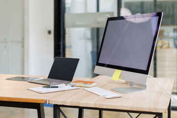 Open desktop with blank screen view of a white-screen desktop computer mockup and accessories on a...