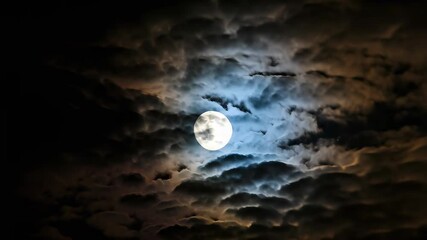A bright full moon shines through dramatic, swirling clouds in the dark night sky - Powered by Adobe
