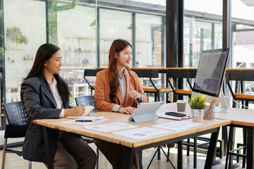 In a sleek glass office space, a team of business professionals engage in lively discussions and exchange strategic ideas, showcasing collaboration and innovation at the heart of modern corporate
