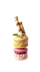 Three colorful macarons stacked, topped with wafer sticks and a sprig of mint