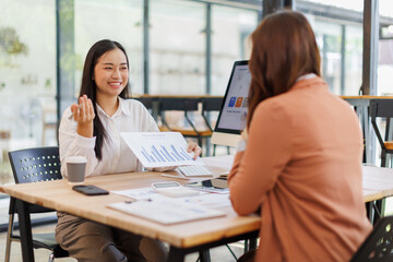 Business people meeting in a business presentation or seminar, documents, graphs and financial or marketing charts are There is a laptop and digital tablet on on desk at work
