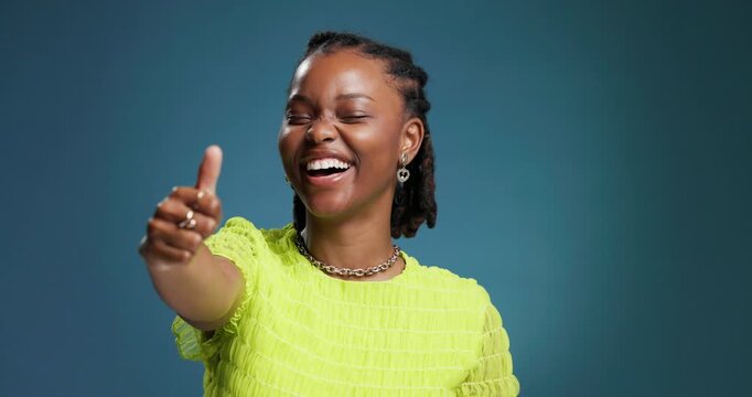 Thumbs up, face and black woman with vote in studio for happiness, approval and good review. Blue background, excited and african person with fashion, mockup space and ok or agreement with hand