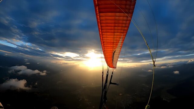Paraglider Flying Over Beautiful Landscape at Sunset