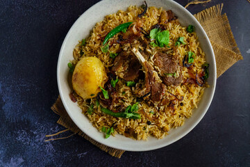 A flavorful serving of mutton pulao or goat meat pilaf, cooked with fragrant basmati rice, ghee, caramelized onions, and aromatic spices. This Bengali-style rice and meat dish blends rich flavors with