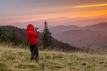 View of a woman photographing the sunrise