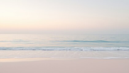 A peaceful seashore at daybreak presents a soft, calming scenery with gentle waves rolling into the sandy coastline