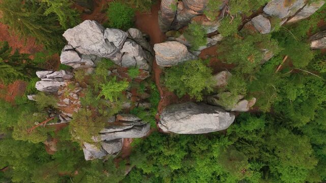 Aerial drone footage captures the geological formations of Prachovsk&eacute; sk&aacute;ly Prachov Rocks in the Bohemian Paradise UNESCO Geopark, Czech Republic. This top down view showcases the unique sandstone roc