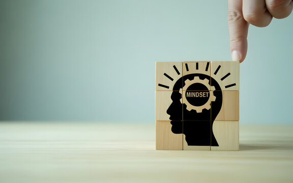 Conceptual image of mindset featuring wooden blocks with a head silhouette and gear, symbolizing mental clarity