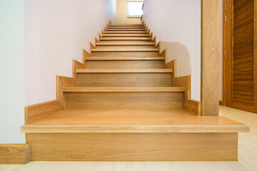 Obraz premium Minimalist teak wood staircase in modern wooden home.