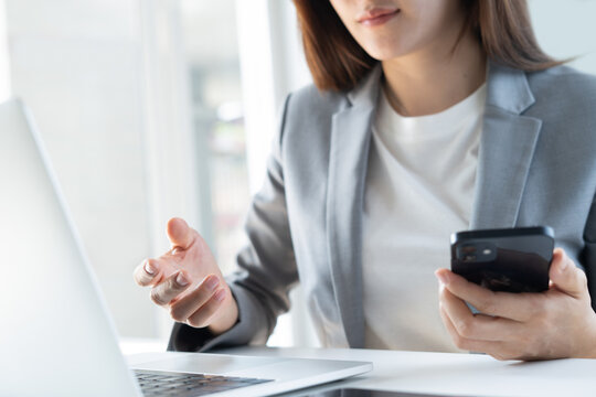 Close up, young asian businesswoman attending on online meeting via laptop computer, web conference. remote work, telecommuting. Entrepreneur woman online working at home office, corporate business