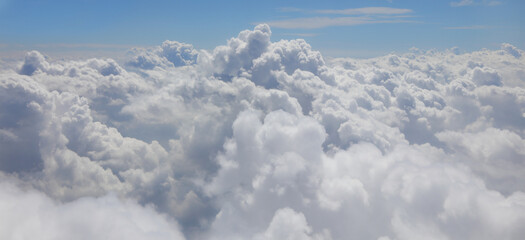 Fototapeta premium white clouds seen from a plane in flight and the blue sky