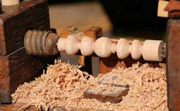 Piece of wood worked on a lathe and wood shavings from the process