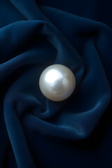 Shiny golden egg or sphere illustration on a luxurious black silk or satin background with dramatic light and reflection, perfect for an Easter or food design concept