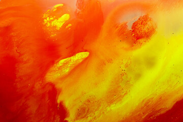 Abstract bold paint flowing on vibrant red orange and gold smear grunge liquid art bubbles texture wallpaper background. Copy space. 