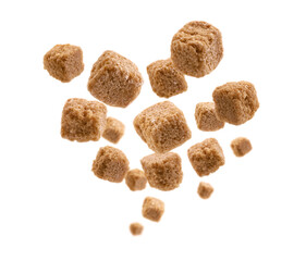 Brown cane sugar levitates on a white background