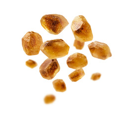 Caramelized sugar levitates on a white background
