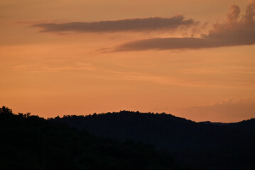 Serene Sunset Over Forested Hill