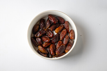 Bowl of Dried Dates on White Background
