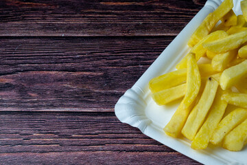 French Fries in Paper Tray on Wooden Table