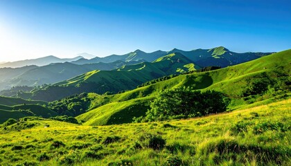Obraz premium Lush Green Hills Under Clear Blue Sky at Daytime in Bright Sunlight with Grassland and Mountain Ranges Landscape Serene Vista Panorama