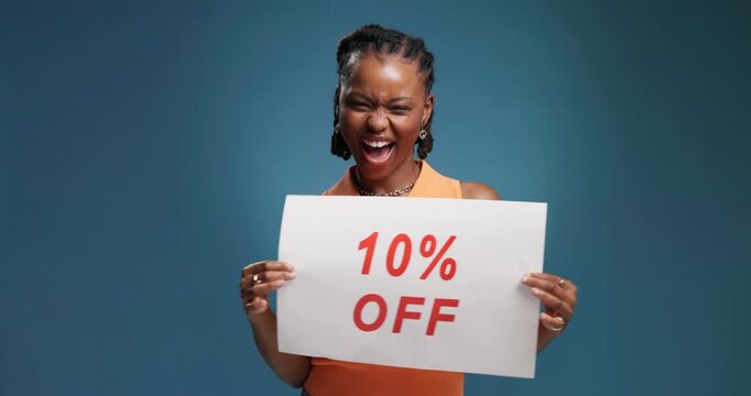Black woman, face and poster with deal in studio for advertising discount on a blue background. Portrait, female person or happy with paper or sale sign for marketing, price off or bargain on space