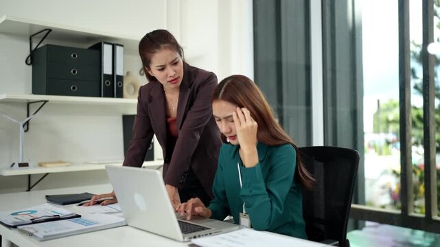 Asian adult business women discuss work performance receive feedback in modern office corporate environment addressing project issues reviewing reports improving output