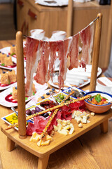 Antipasti in the restaurant, exquisite serving of meat appetizers, jamon, ham, salami, olives, sauce
