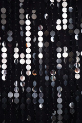 Abstract background with flickering and glittering silver metallic particles or sequins on the wall
