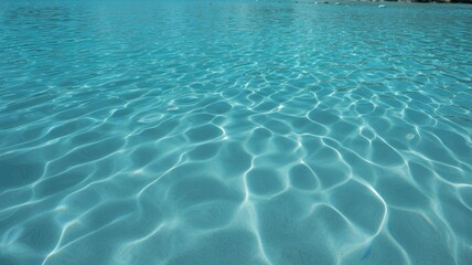 Fototapeta premium Crystal clear turquoise water with shimmering sunlight patterns, perfect for summer relaxation and refreshing poolside vibes.