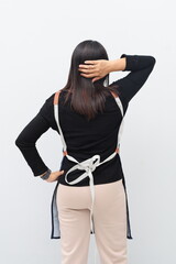 Rear view of an adult woman in an apron scratching her head, showing a confused gesture, isolated on a white background.