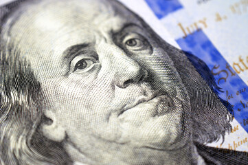 A portrait of Benjamin Franklin on the obverse side of 100 USD one hundred American dollars cash money bill, also features the Declaration of Independence in the background with a feather