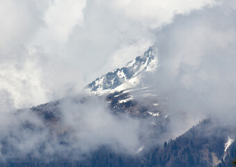 Mountain covered in snow and clouds