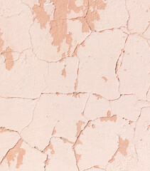 A wall with a lot of cracks and holes