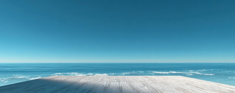 Wooden pier overlooking a serene and vast blue ocean on a sunny day