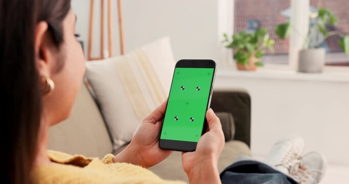 Woman, hands and phone with green screen on sofa for online entertainment, UI or UX in home. Back view, female person or user with mobile smartphone display or chromakey for app on mockup space