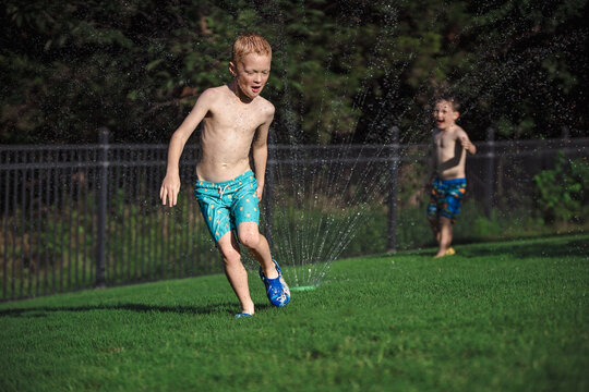 Summertime backyard Sprinkler Fun with Boys