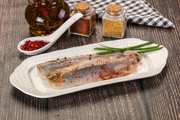Salted marinated herring fillet with spices