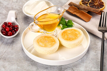 Fototapeta premium Roasted cheesecakes - Syrniki with honey